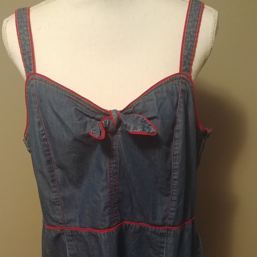 Super cute thin denim sundress with red trim.